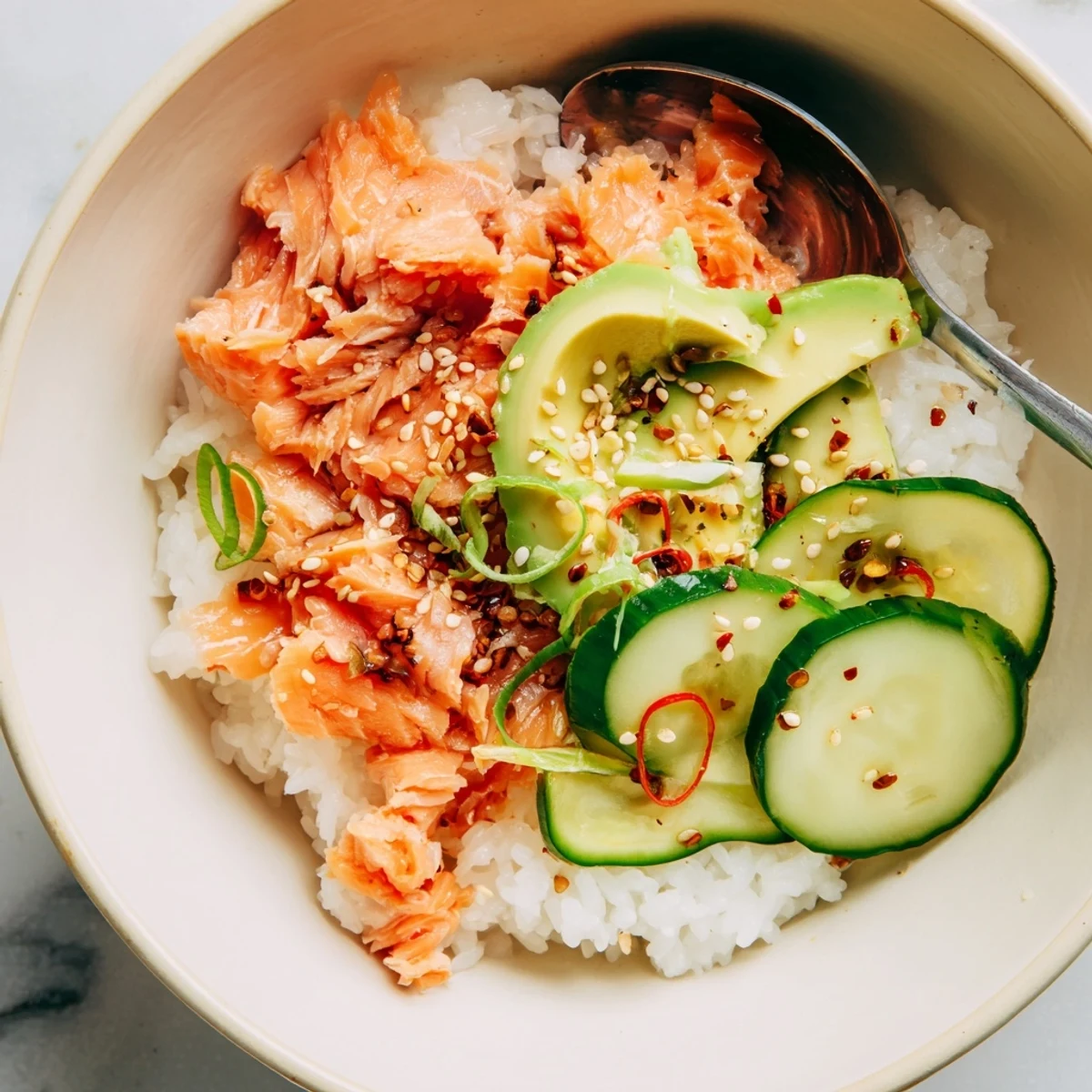 Delicious Leftover Salmon & Rice Bowl garnished with fresh avocado and pickled ginger. 