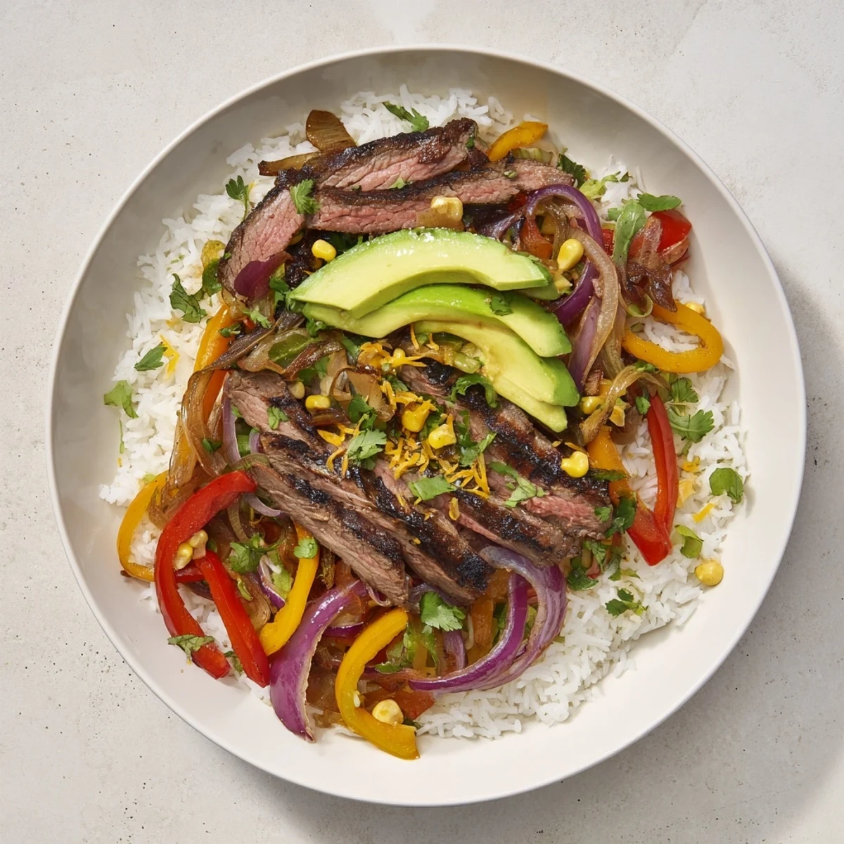 A visually appealing BBQ Steak Fajita Bowl with tender steak, fresh toppings, and fluffy rice for a satisfying meal.