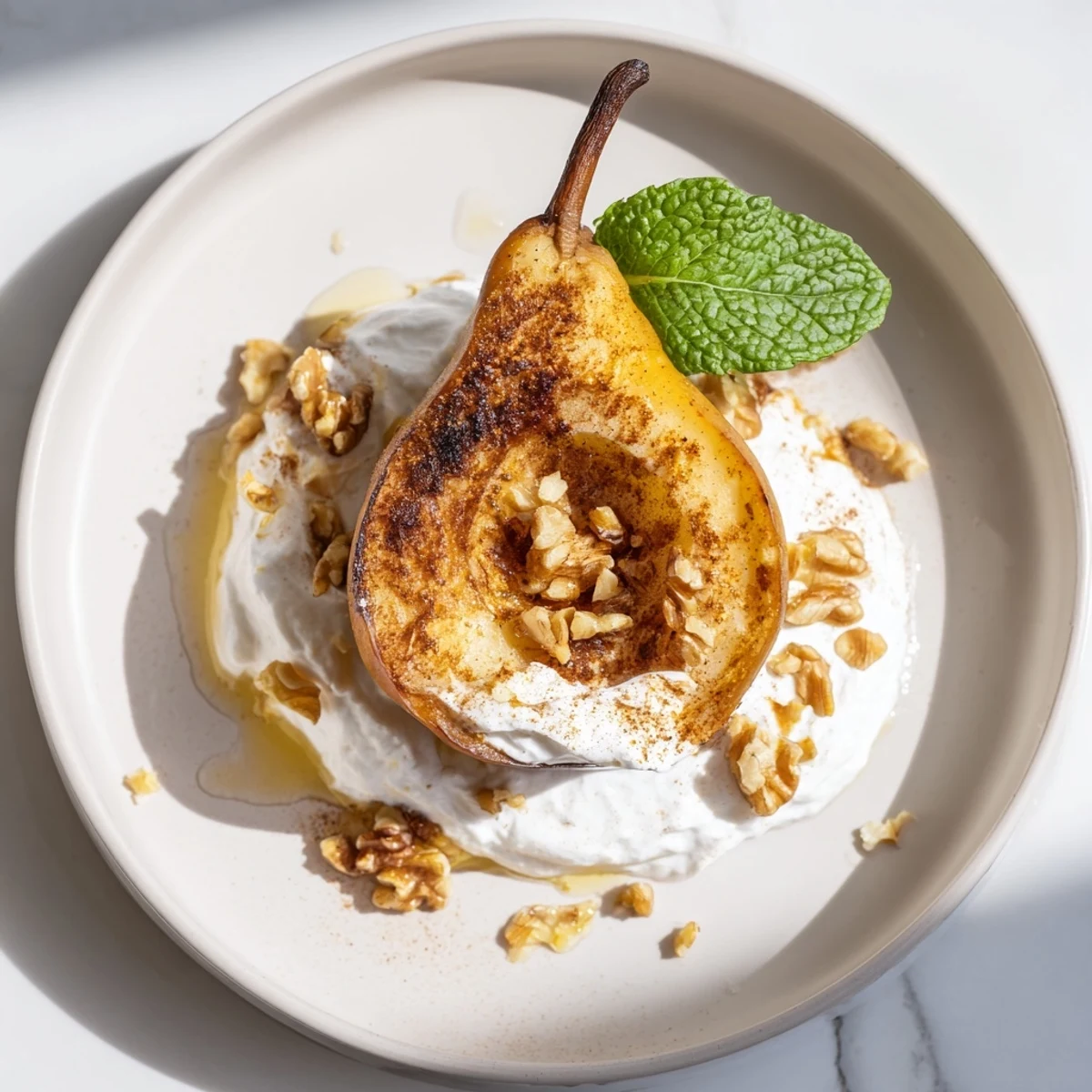 Golden caramelized roasted pears with cinnamon, walnuts, and Greek yogurt make a delicious dessert.
