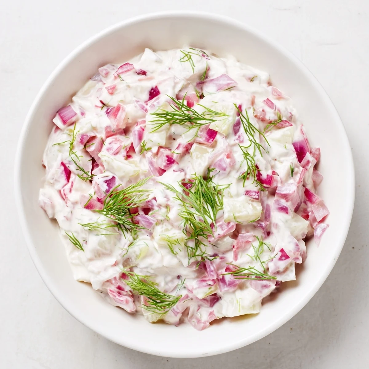 Chilled sweet and sour pickle relish dip, a vibrant, tangy appetizer with visible chopped red onion and dill.