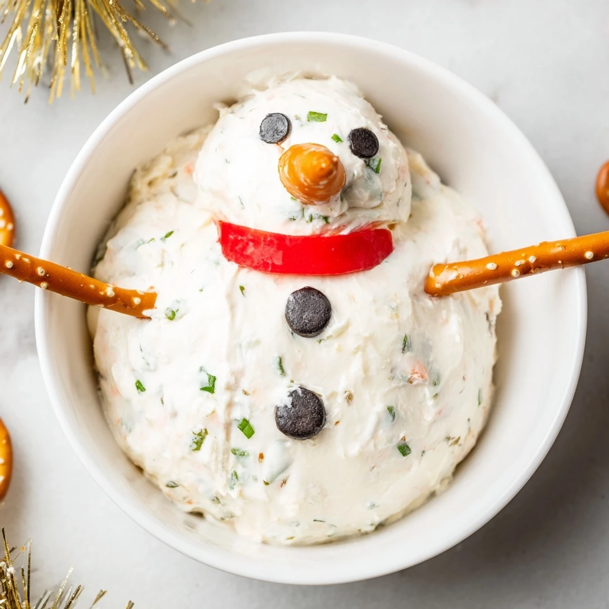 Warm and creamy melted snowman dip bowl, a festive American appetizer ready for dipping.