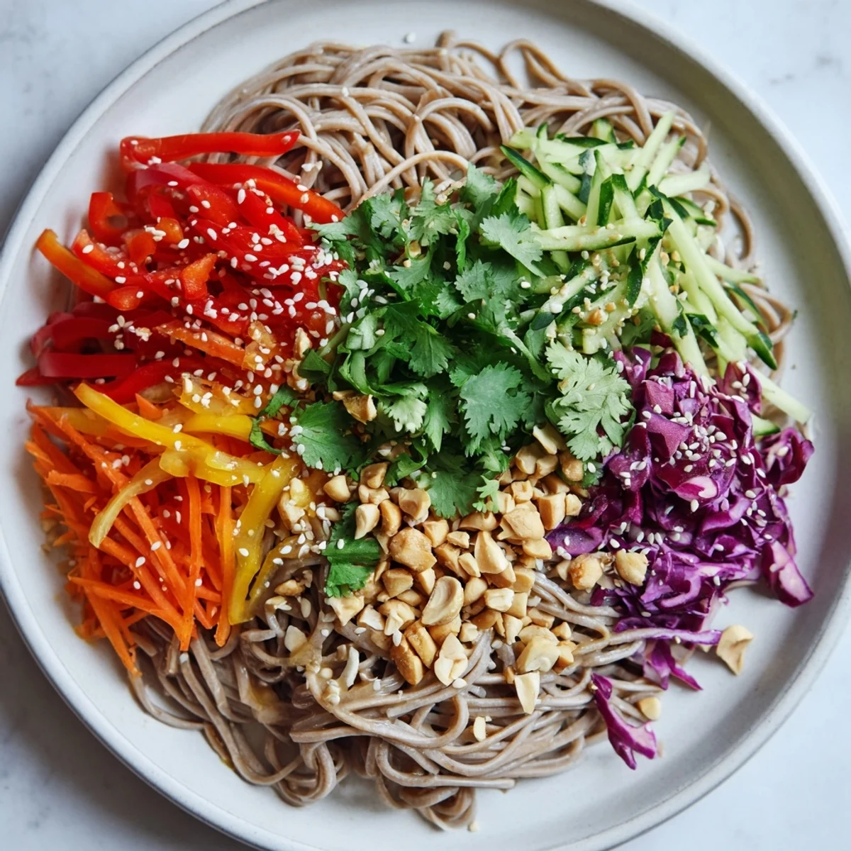 Vibrant Cold Noodle Salad showing tender noodles, colorful veggies, and sesame-ginger drizzled over.