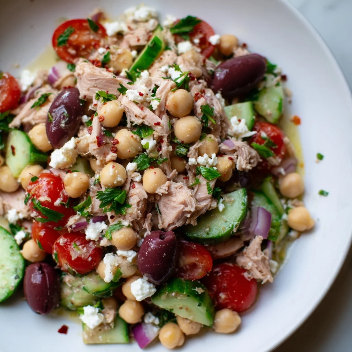 A fresh bowl of Tuna Chickpea Salad with vibrant tomatoes and lemon dressing, ready to enjoy.