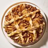 Warm Lattice Orchard dessert, featuring a detailed lattice crust over a sweet walnut filling, so inviting.