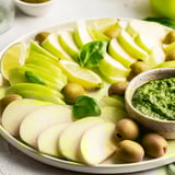 Vibrant The Emerald City appetizer, full of fresh limes, crisp apples, and savory pesto for snacking.
