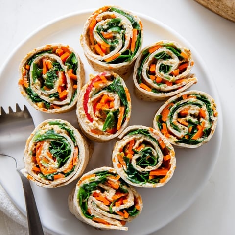 Veggie Hummus Pinwheels: Colorful, bite-sized appetizers featuring vibrant vegetables rolled in soft tortillas.