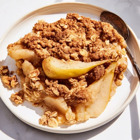 Golden Spiced Pear Crisp, bubbly and fragrant, ready to serve with ice cream.