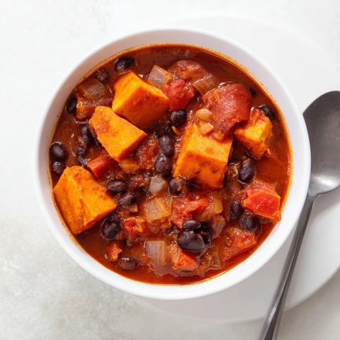 Sweet potato and black bean chili simmers invitingly, ready for a chilly evening meal.