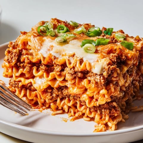 Spicy Ramen Lasagna with melted cheese and rich meat sauce, perfect for dinner.  