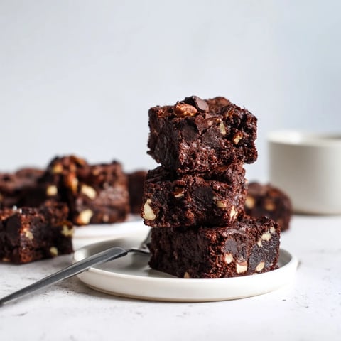 Rich zero-waste brownies using nut-milk pulp topped with dark chocolate chips.  