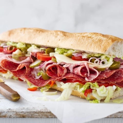 Vibrant Flavor Mash-Up Sandwiches loaded with meats, cheeses, and fresh vegetables.