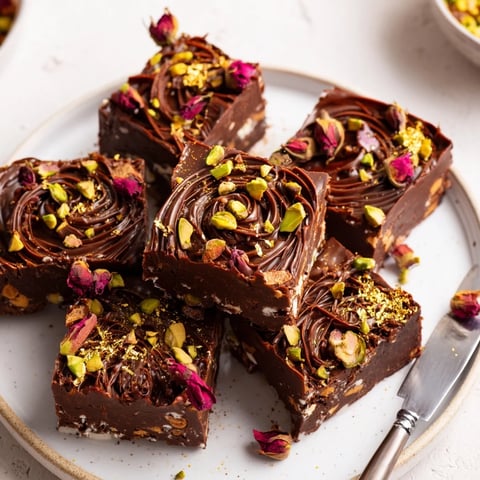 Decadent chocolate bar inspired creations topped with rose petals and pistachios.