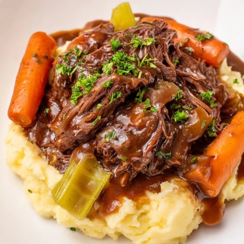 Tender Slow Cooker Pot Roast with rich gravy, served beautifully over fluffy mashed potatoes.