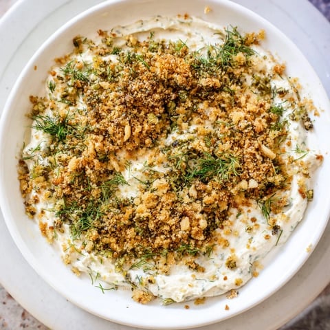 Creamy fried pickle dip, a vibrant appetizer ready to scoop up with crunchy potato chips.