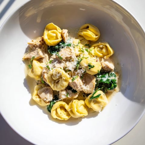 Creamy Chicken and Spinach Tortellini, a rich pasta dish with a creamy Parmesan sauce and tender chicken.