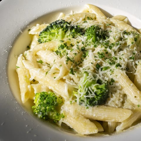 Steaming Cream Cheese Garlic Pasta with vibrant green broccoli and creamy, garlicky sauce ready to serve.
