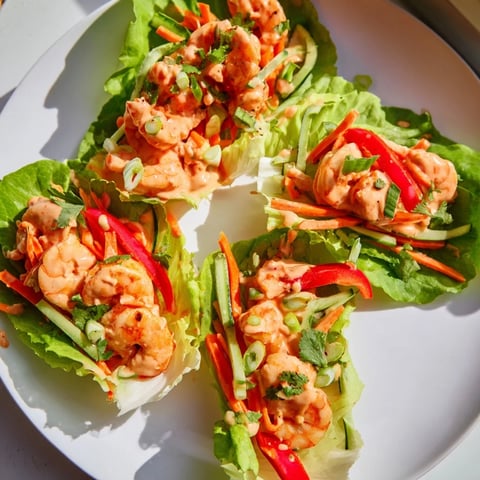 Vibrant shrimp lettuce cups filled with colorful veggies and spicy shrimp, ready to enjoy.