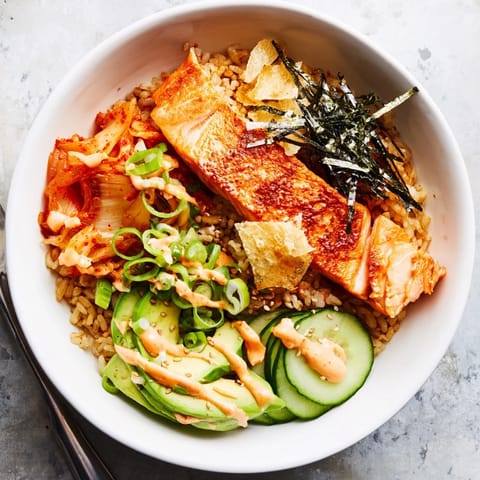 Flavorful crispy salmon served over golden, crunchy rice and tangy kimchi.  