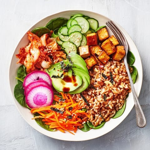 Vibrant fermented vegetable bowl showcasing kimchi, crunchy radishes, and hearty grains.  