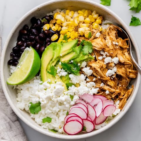 Delicious Green Enchiladas Rice Bowl with zesty chicken, rice, and vibrant veggies.  