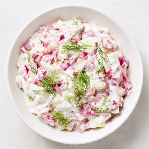 Chilled sweet and sour pickle relish dip, a vibrant, tangy appetizer with visible chopped red onion and dill.