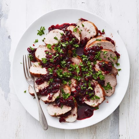 Juicy slices of Tart Cherry Date Glazed Pork Tenderloin, offering sweet and savory American flavors.
