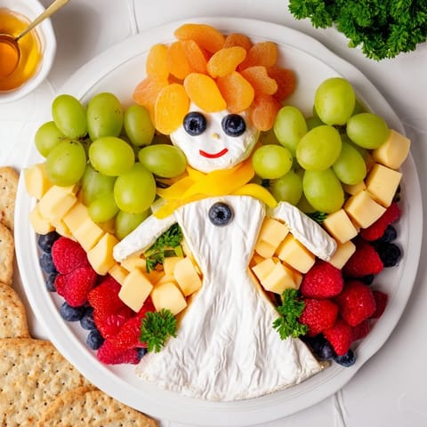 Artfully arranged Cherub Angel Snack Tray, presenting a colorful, eye-catching party appetizer of cheese and fruit.