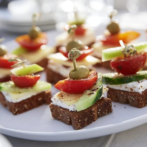 Savory Urban Skyscraper Appetizers, beautifully stacked with cheese, veggies, and crackers ready to eat.