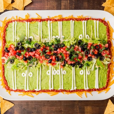 A close-up shot of a creamy, delicious Football Field Dip, ready for the game day party.