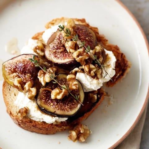 Elegant Royal Tapestry appetizer with creamy goat cheese, figs, walnuts, and toasted brioche.