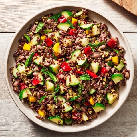 This luscious Dense Bean Salad features a medley of beans, herbs, and a cocoa powder sprinkle.