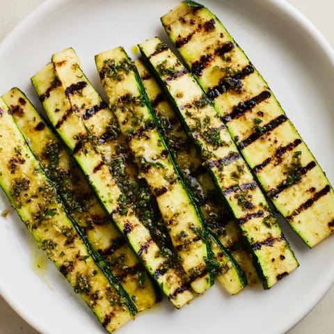 Close-up of vibrant, marinated garlic herb grilled zucchini, a flavorful Mediterranean delight.