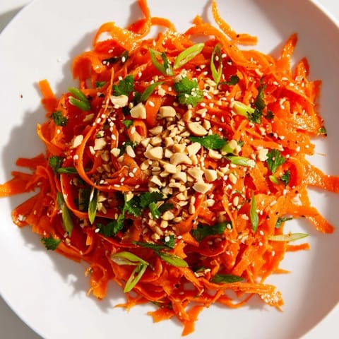Fresh, crunchy Spicy Carrot Salad with bright orange carrots and a glistening sesame dressing, ready to enjoy.
