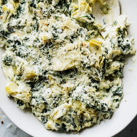 Golden-brown spinach artichoke dip, a creamy, cheesy dream perfect for your next gathering.