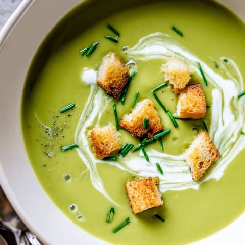 Garnished creamy broccoli soup, incredibly smooth and flavorful, ready to serve.