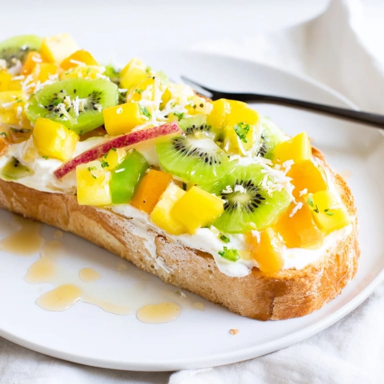 Indulge in yogurt-custard toast, vibrant with mango and pineapple toppings.  