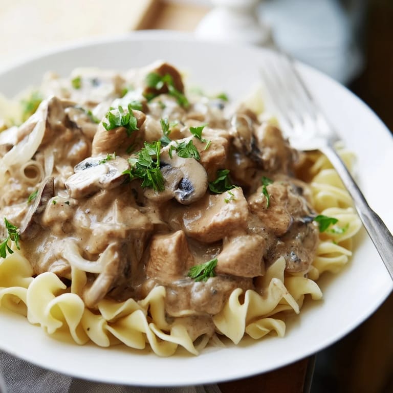 Comforting bowl of Creamy Chicken Stroganoff, perfect for weeknight dinners with rice.
