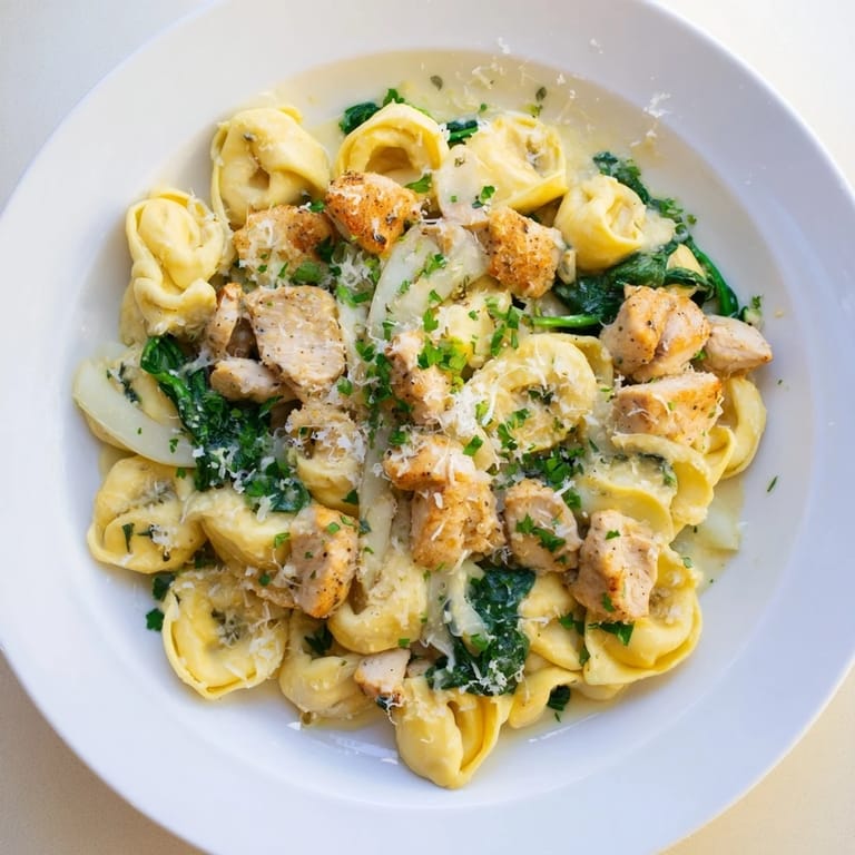 Fluffy cheese tortellini mingle with spinach and creamy sauce in this easy Creamy Chicken and Spinach Tortellini recipe.