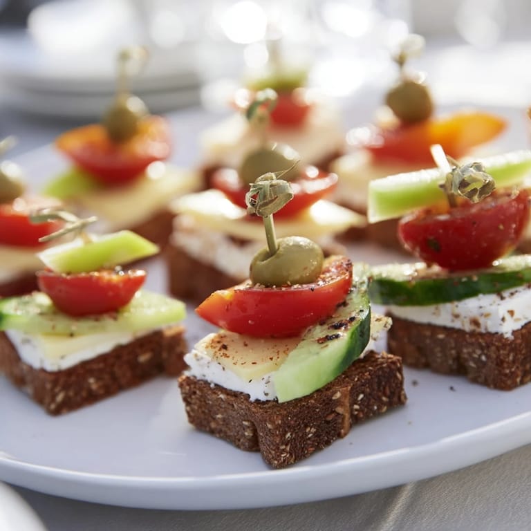 Savory Urban Skyscraper Appetizers, beautifully stacked with cheese, veggies, and crackers ready to eat.